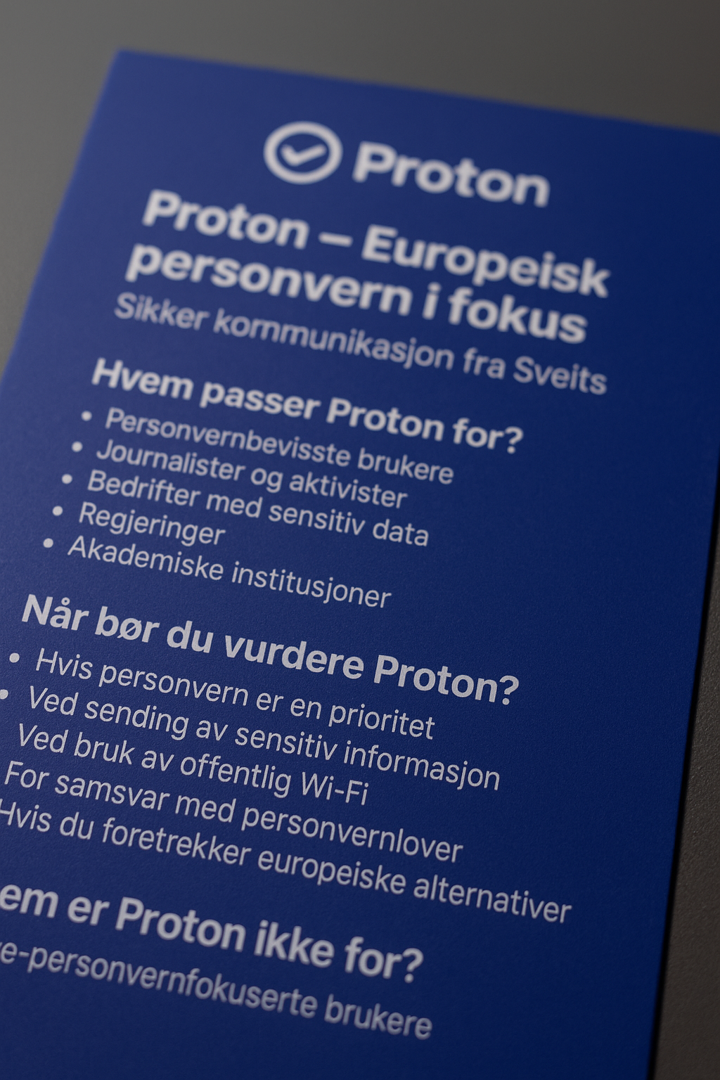 Et nærbilde av en fysisk Proton-plakat med fokus på personvern, fotografert i skrå vinkel med profesjonell belysning, tydelig logo og punkterte lister over hvem Proton passer for og når det bør vurderes.